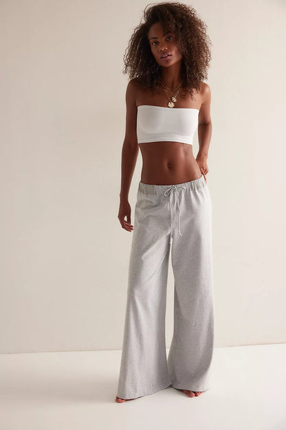 Model wearing gray micro-stripe wide-leg lounge pants with drawstring waistband
