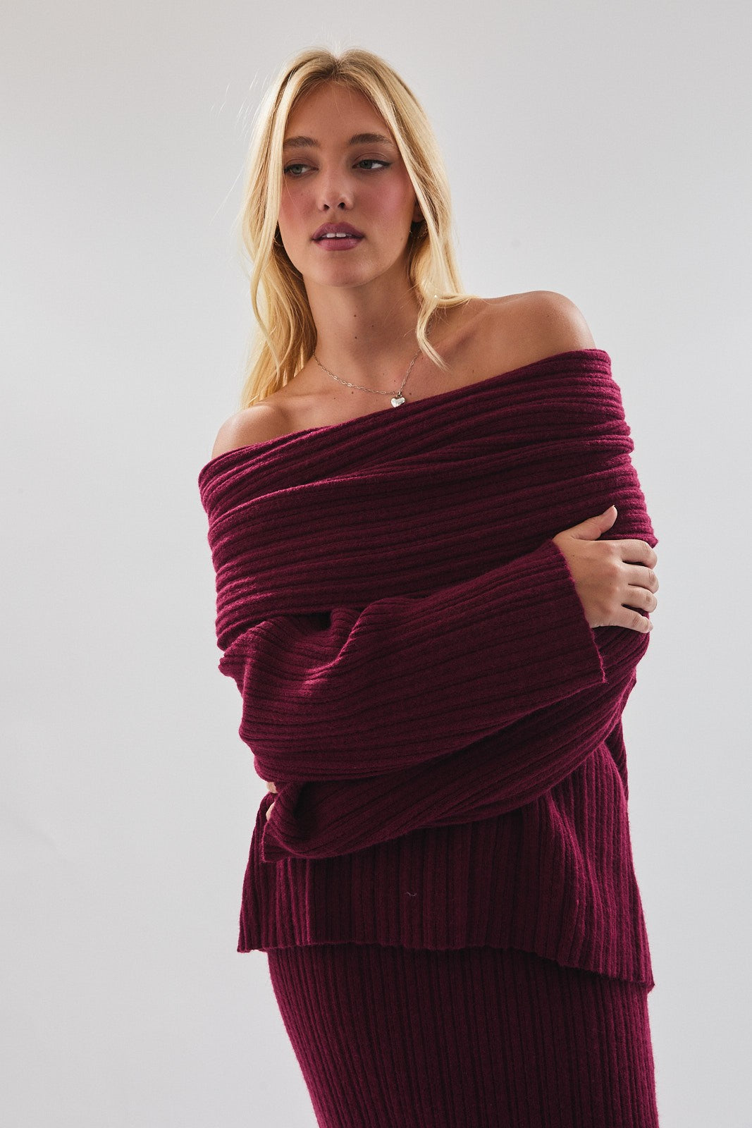 Model wearing Merlot Muse Sweater, oversized off-shoulder ribbed knit in merlot with matching skirt