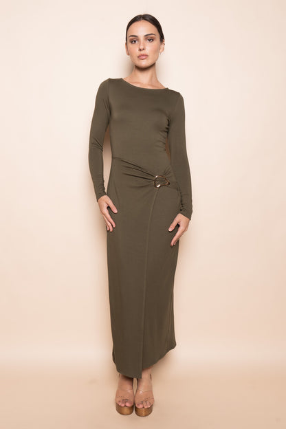 Woman wearing sculpted buckle maxi dress in olive with wrap panel and gold buckle