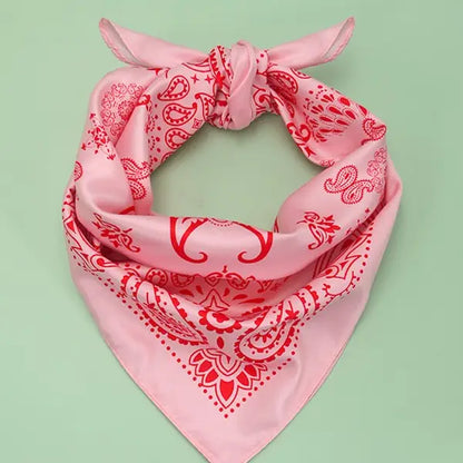 Pink bandana with red patterns on a light green background