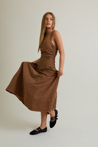 Model wearing Autumn Plaid Dress, sleeveless plaid square neck dropped waist midi in warm chestnut tones
