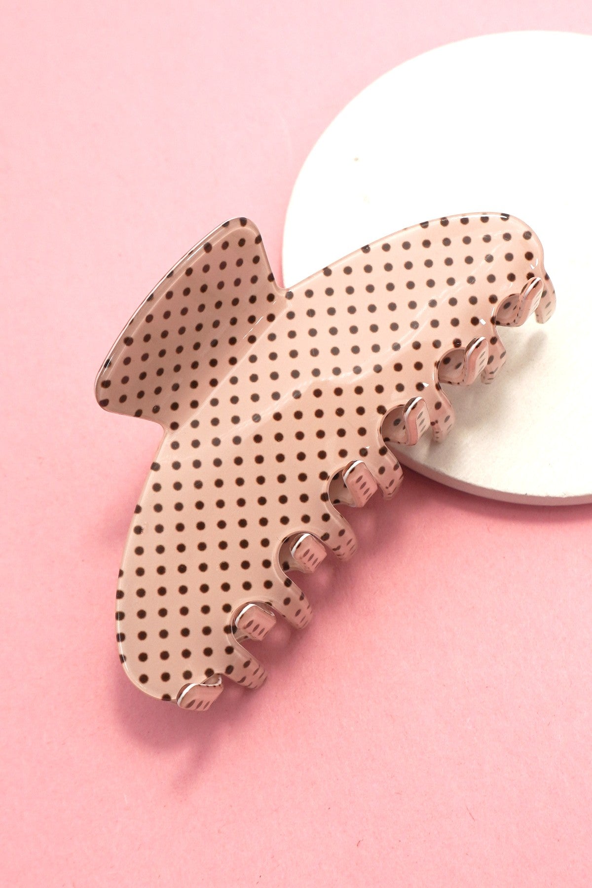 Polka dot butterfly clip on a pink background