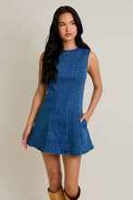 Load image into Gallery viewer, Model wearing sleeveless round-neck denim mini dress with A-line silhouette and side pockets