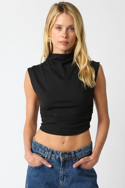 Model wearing the Sarah Cropped Top in black with turtleneck and fitted cropped silhouette