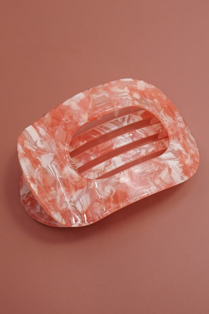 Marble-patterned soap dish on a brown background