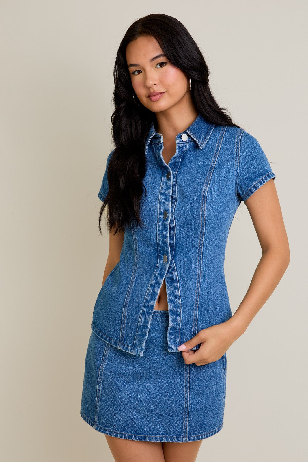 Model wearing Classic Edge Denim Top in blue cotton with button-front design