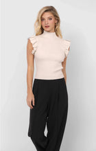 Load image into Gallery viewer, Model wearing cream knit mockneck tank sweater with ruffle sleeves and black trousers