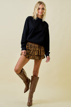 Load image into Gallery viewer, Model wearing Untamed Tiered Skort with tiger-zebra print, tiered ruffles, and built-in shorts styled with tall brown boots.