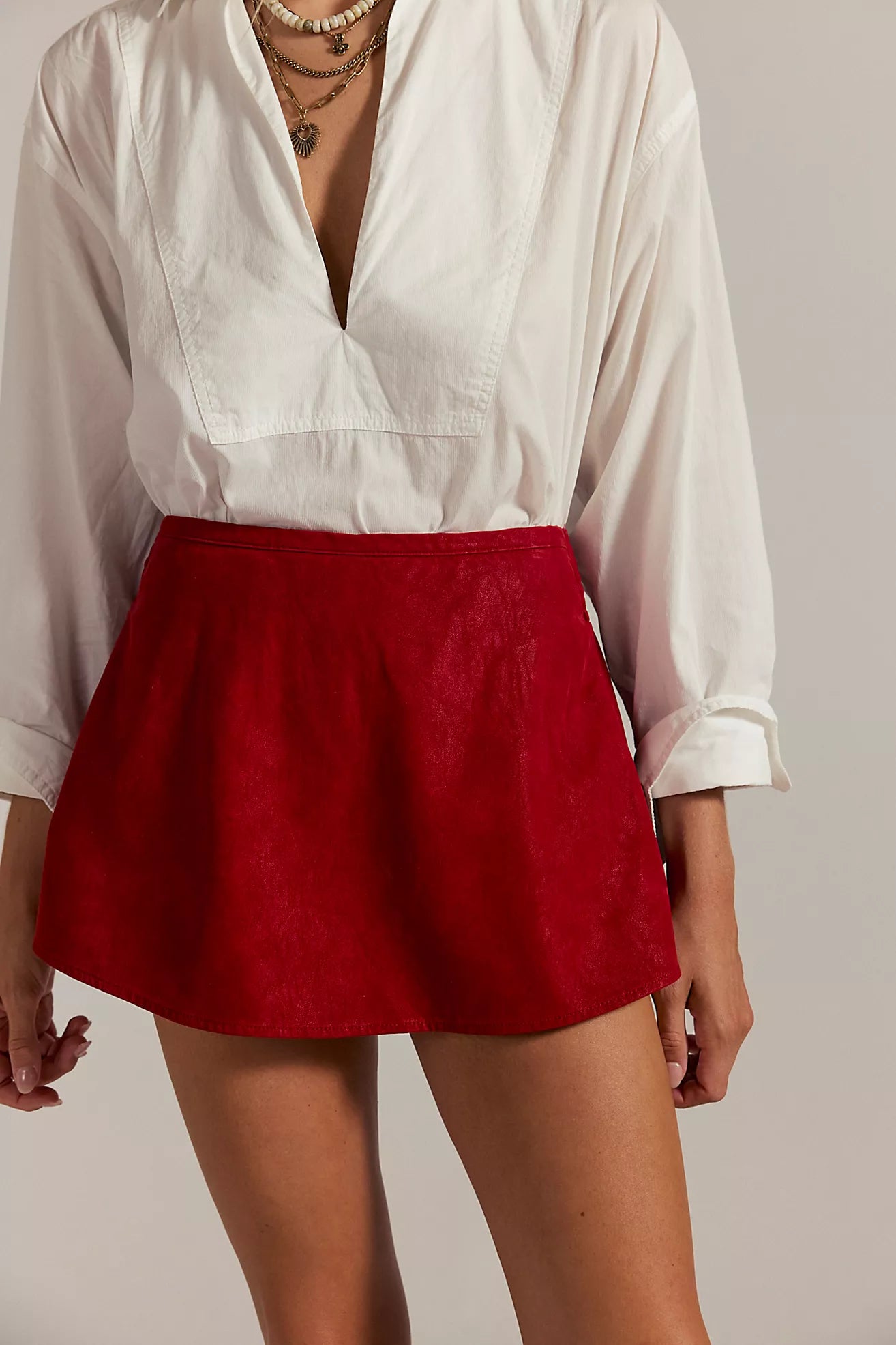 Vegan suede red mini skort with mid-rise fit, side pockets, and shorts lining