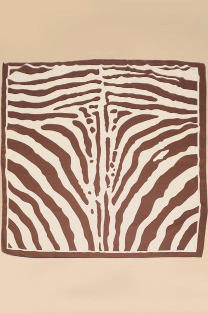 Square scarf with brown and white zebra pattern on a beige background